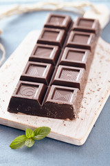 Dark chocolate on a white chopping board, light and bright colors