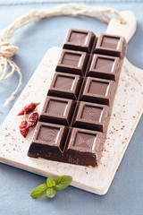 Dark chocolate on a white chopping board, light and bright colors