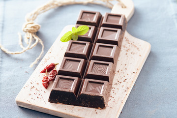 Dark chocolate on a white chopping board, light and bright colors