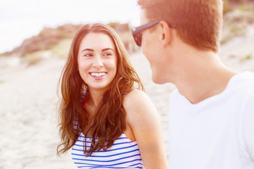 Romantic young couple sitting on the beach