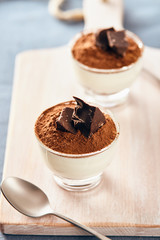 Panna cotta with chocolate on a white chopping board, bright colors