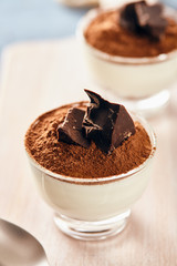 Panna cotta with chocolate on a white chopping board, bright colors