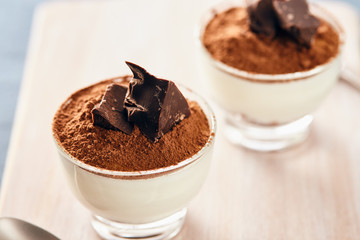 Panna cotta with chocolate on a white chopping board, bright colors