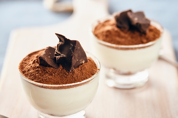 Panna cotta with chocolate on a white chopping board, bright colors