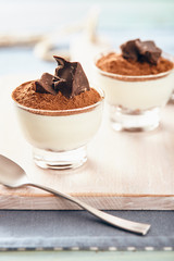 Panna cotta with chocolate on a white chopping board, bright colors