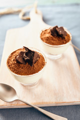 Panna cotta with chocolate on a white chopping board, bright colors