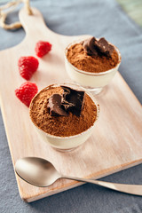 Panna cotta with chocolate on a white chopping board, bright colors