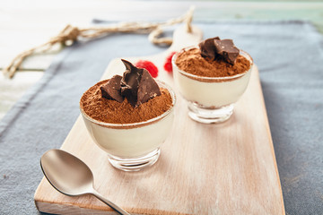 Panna cotta with chocolate on a white chopping board, bright colors