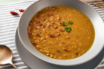 bean and spelt soup on a wooden table, bright colors
