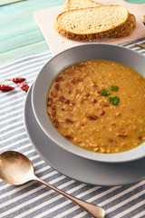 bean and spelt soup on a wooden table, bright colors