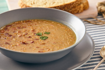 bean and spelt soup on a wooden table, bright colors