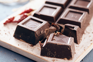 Dark chocolate on a white chopping board, light and bright colors