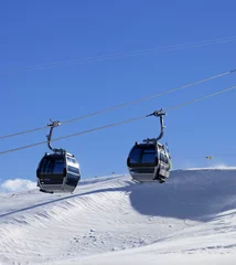 Fotobehang Gondola lift on ski resort at windy sun day © BSANI