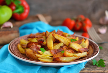 Young fried potatoes with bacon and onions