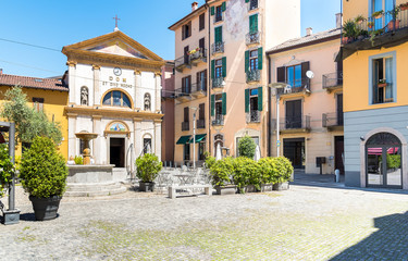 Fototapeta na wymiar Piazza San Rocco with restaurant, fountain and church in the historic center of Verbania Intra, Italy