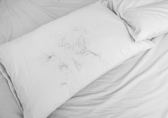 Hair loss with Pillow on the bed, background
