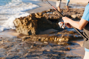 Teenage boy fishing at sea