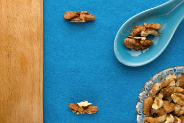 Walnuts. Top view of wooden Board and blue background. For kitchen and menu 