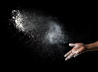 Fotobehang Hand and flour on black background © showcake