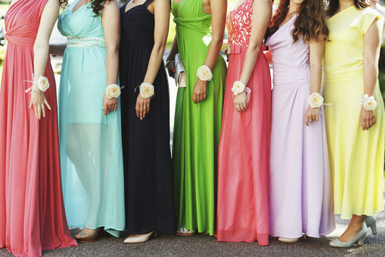 Happy bridesmaids in multicolored dresses