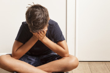 sadness child hands on face