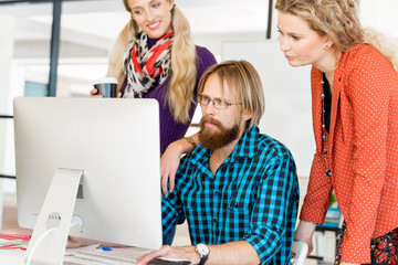 Young office workers discussing