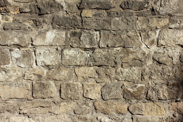 a fragment of a stone wall of an ancient castle