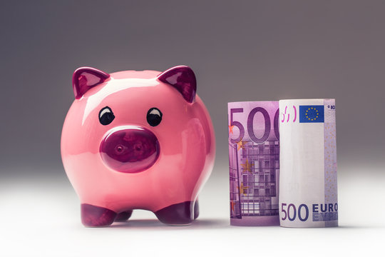 Piggy bank.Pink Piggy save and Five hundred Euro banknotes.Toned photo.