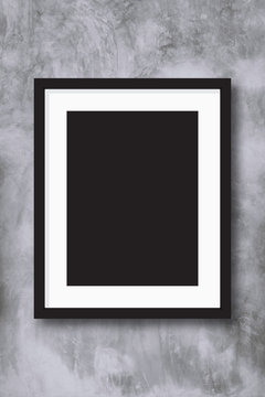 Black photo frame on concreate wall background.