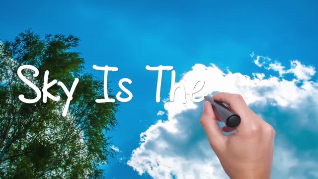 The Sky Is The Limit cloud with a blue sky. Man Hand writing  with black marker on the sky. Amazing Time Lapse blue sky clouds and sun shining. Big dreams, hopes and aspirations. 4k