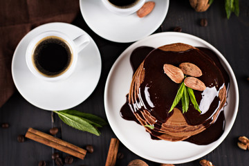 chocolate pancakes with chocolate sauce. coffee. breakfast