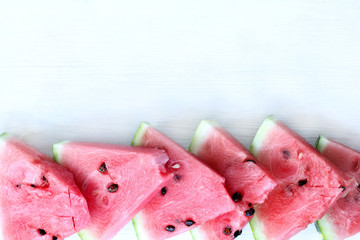 appetizing pieces of red delicacy/ flat layout of slices of watermelon lying on a wooden surface light 