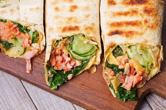 Salmon, Spinach, Cheese And Cucumber Burritos. View From Above, Top Studio Shot