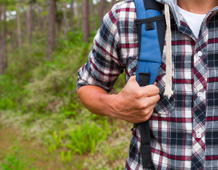 Male hiking through forest. 