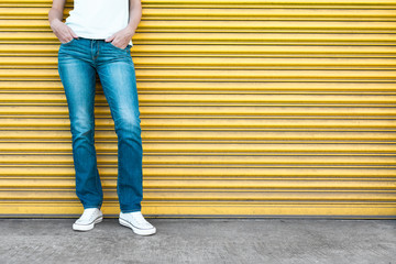 Girl posing in jeans against garage door. 