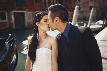 Stylish happy newlyweds in Venice