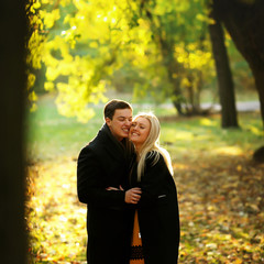 Beautiful young couple in the autumn park