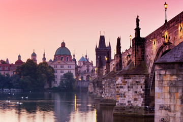 Fototapeta na wymiar romantic red sunrise over Moldau river, Charles bridge, Old Town Bridge Tower (UNESCO), Old Town, Prague, Czech Republic 