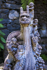 Obraz premium Asian stone dragon in garden.