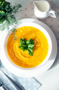 Pumpkin soup with potatoes, carrots and parsley