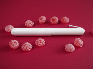 Tampon  with red candies on red background