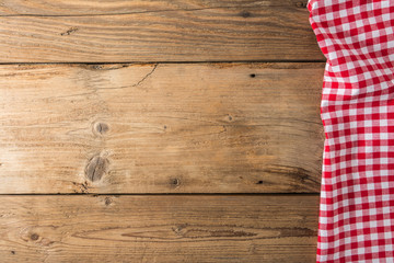 Checkered tablecloth red on the wooden background/ texture
