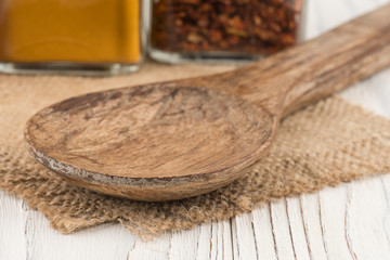 Fototapeta na wymiar Wooden spoon on an old white wooden table.