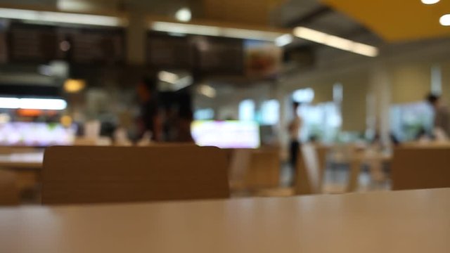under table and chair at food court blurred background