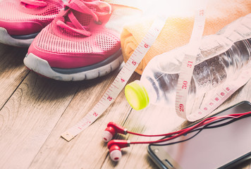 Naklejka premium Sneakers, towel, water, tape measure, earphones and smart phone