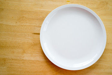 White Empty plate on old wooden background, Top view with copy space