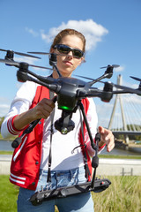 Fototapeta na wymiar woman holding drone uav over a field. Aerial video and photogra