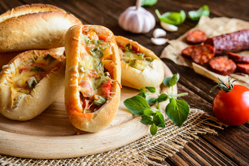 Bread boats filled with sausage, egg and cheese
