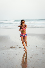 Black sporty woman dancing at the beach. Female brazilian dancer training against the sea.