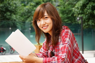 Young asian girl studying outside in university